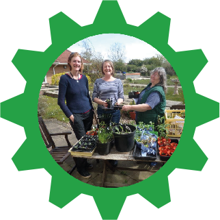 Image of people with the produce they have grown in the garden